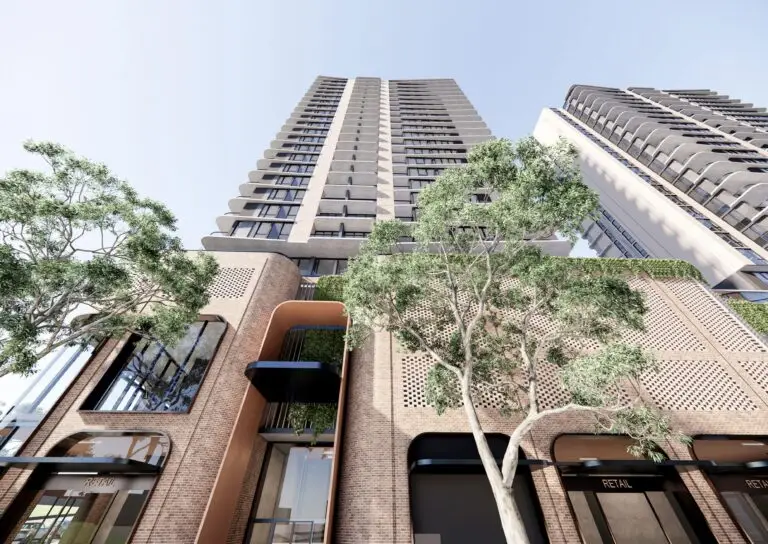 Rendering of the Compass Centre redevelopment in Bankstown, featuring high-rise towers with a brick podium, large windows, and greenery, framed by trees.