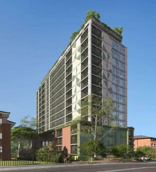 15-storey modern residential building with geometric panels, glass facade, rooftop greenery, and ground-level landscaping in an urban setting under a clear blue sky.