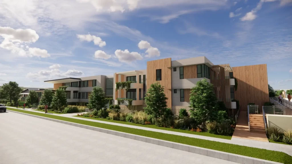 Proposed design of the seniors housing redevelopment in Towradgi, showing modern low-rise buildings with timber accents, large windows, and landscaped gardens under a blue sky.