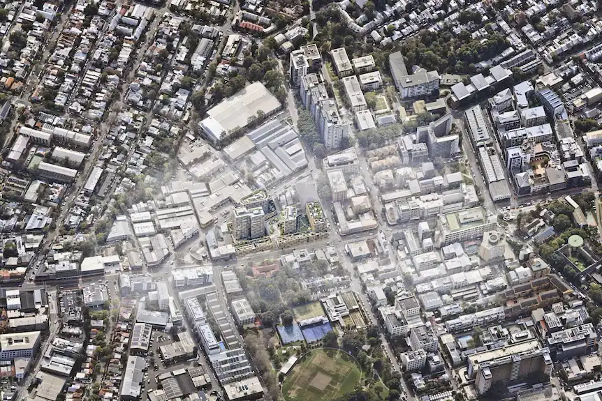 An aerial view of Camperdown, showcasing a proposed mixed-use build-to-rent development. The image highlights the surrounding urban landscape, including residential and commercial buildings, green spaces, and key infrastructure.