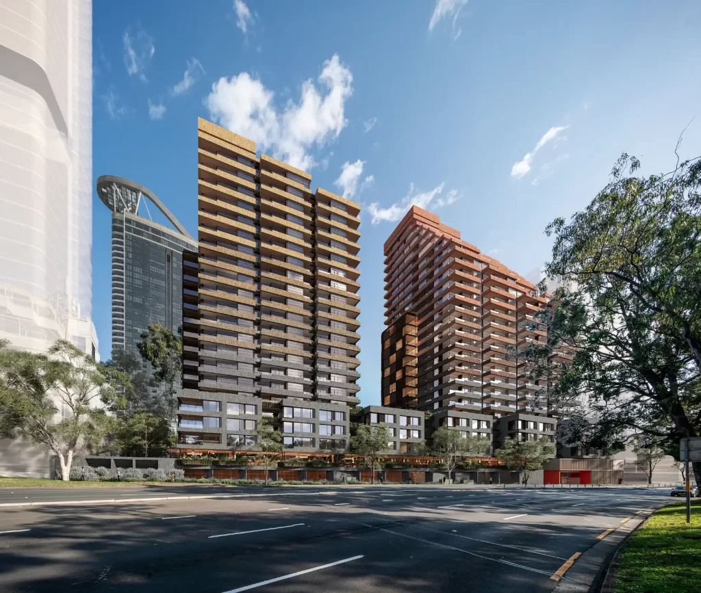 Proposed Rhodes East Mixed Use Development, featuring two high-rise residential towers with modern architectural design, surrounded by greenery and set against a blue sky.