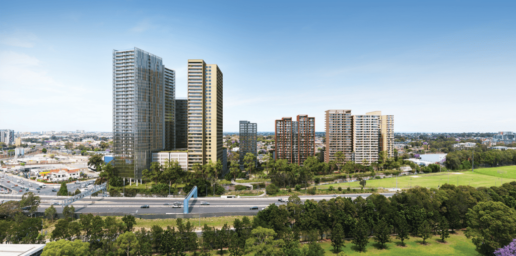 Rendered image of a proposed mixed-use development at 1 Crescent Street, Holroyd, showcasing multiple high-rise residential and mixed-use buildings surrounded by greenery, with a highway and open parklands in the foreground.