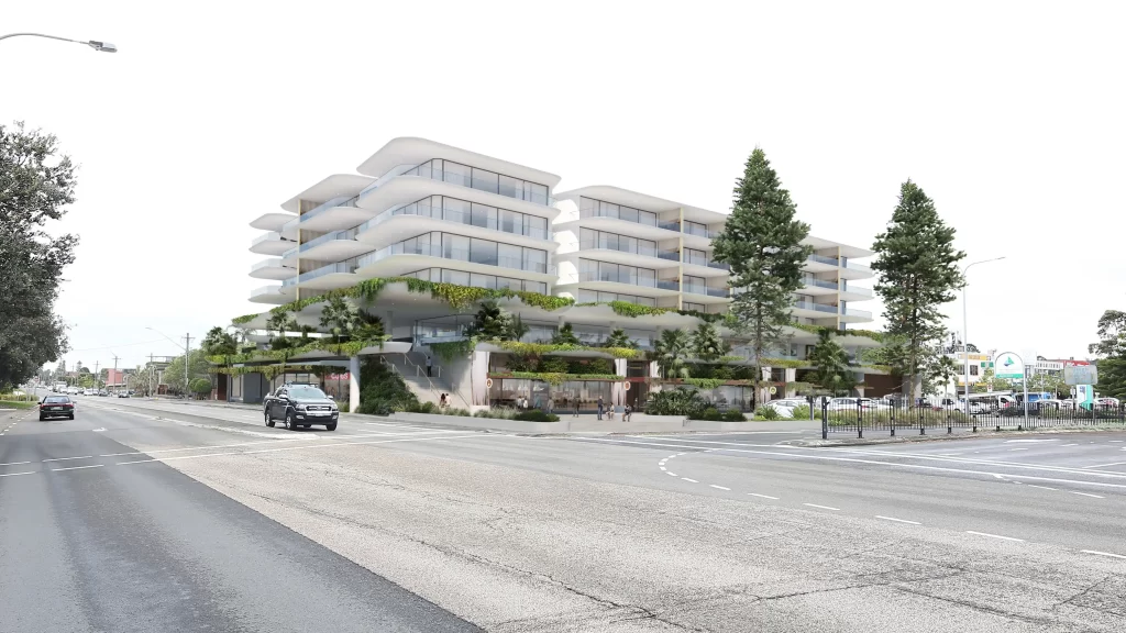 Proposed mixed-use development at 277 The Grand Parade, Ramsgate Beach, featuring a six-storey modern building with curved balconies, landscaped greenery, and retail spaces at the ground level, as viewed from the street intersection.