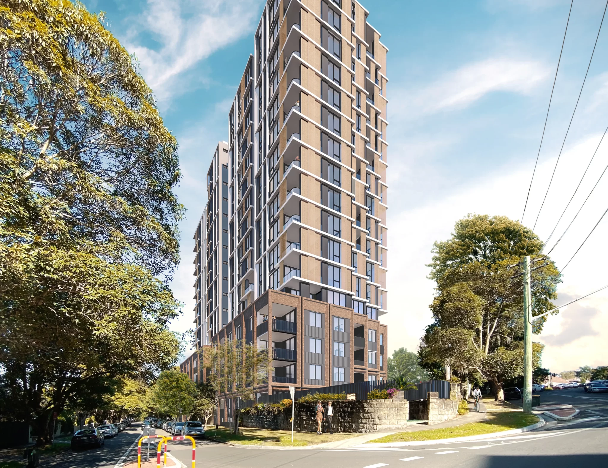 Street-level view of a 16-storey residential apartment building in St Leonards South, with modern architecture and a landscaped frontage, surrounded by mature trees and a quiet suburban street.