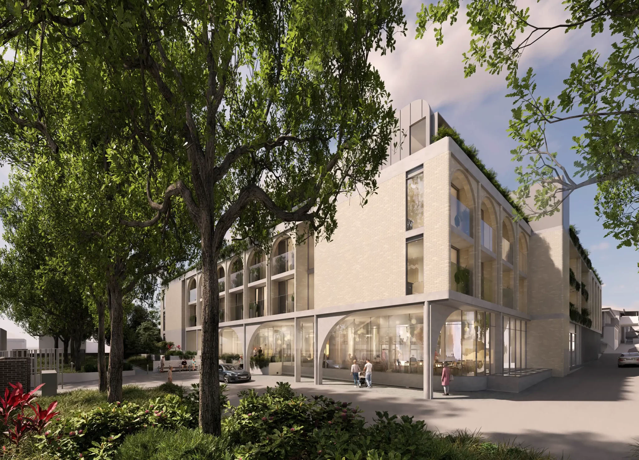 Render of a four-storey aged care facility in Marrickville, with arched glass facades, surrounded by mature trees and landscaped gardens.