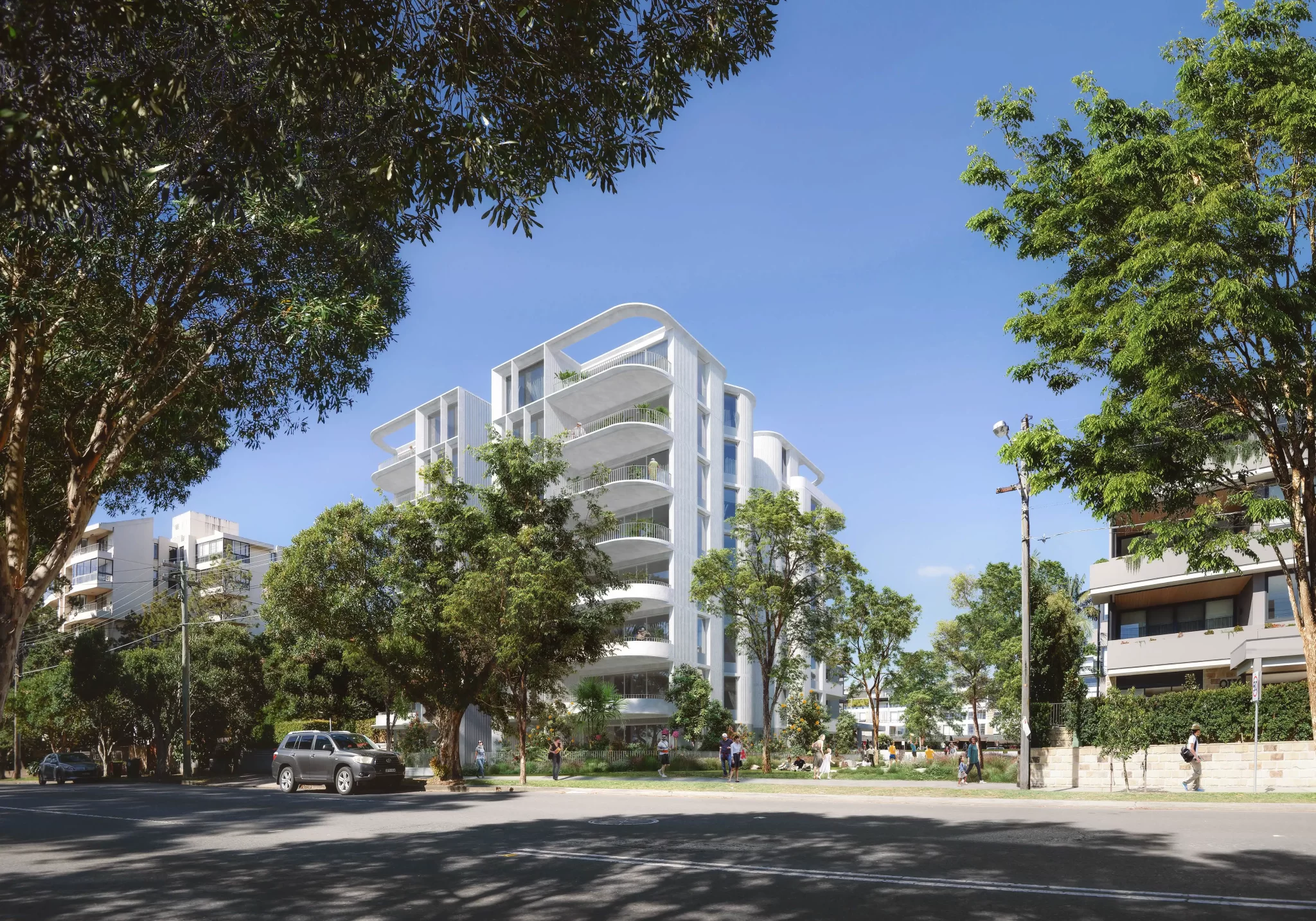 Render of a white, multi-storey seniors housing building with curved balconies and surrounding trees, viewed from the street.