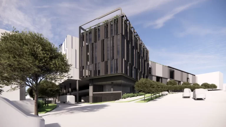 Architectural render of the proposed Woolworths warehouse and Customer Fulfilment Centre at 144 Wicks Road, Macquarie Park, showing a multi-storey dark-toned façade with rooftop greenery.