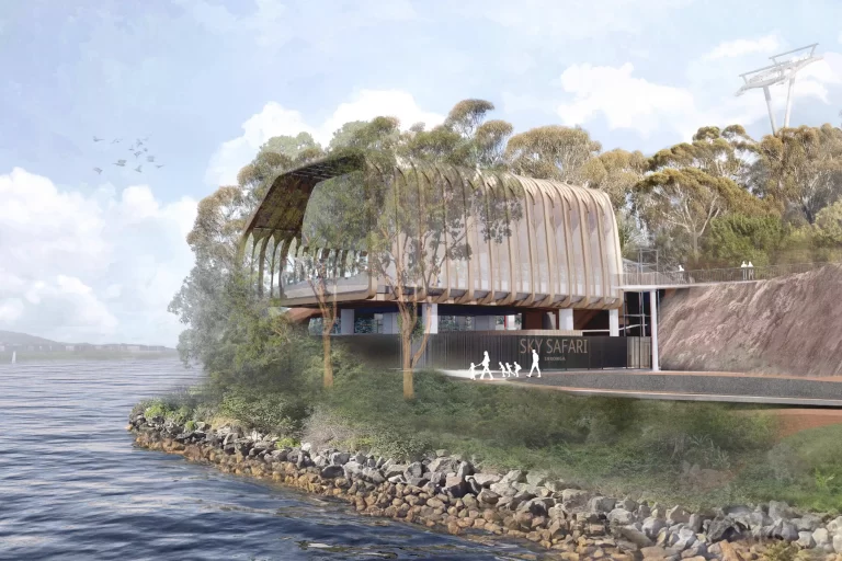 Architectural rendering of the proposed Sky Safari lower station at Taronga Zoo, featuring a curved timber facade, elevated structure, and waterfront setting.