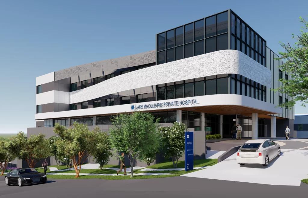Rendered image of Lake Macquarie Private Hospital showing a modern multi-storey medical building with landscaped gardens and vehicle access at the entrance.