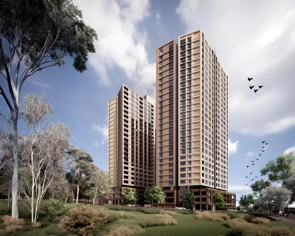 Architectural render of two high-rise apartment towers in Westmead, surrounded by landscaped greenery and trees under a partly cloudy sky.
