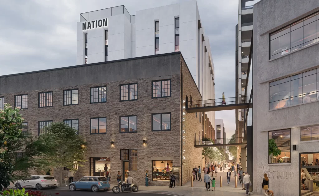 Rendered street-level view of Precinct 75 in St Peters, showing retained brick buildings, pedestrians, a sky bridge, and new Nation-branded BTR tower.