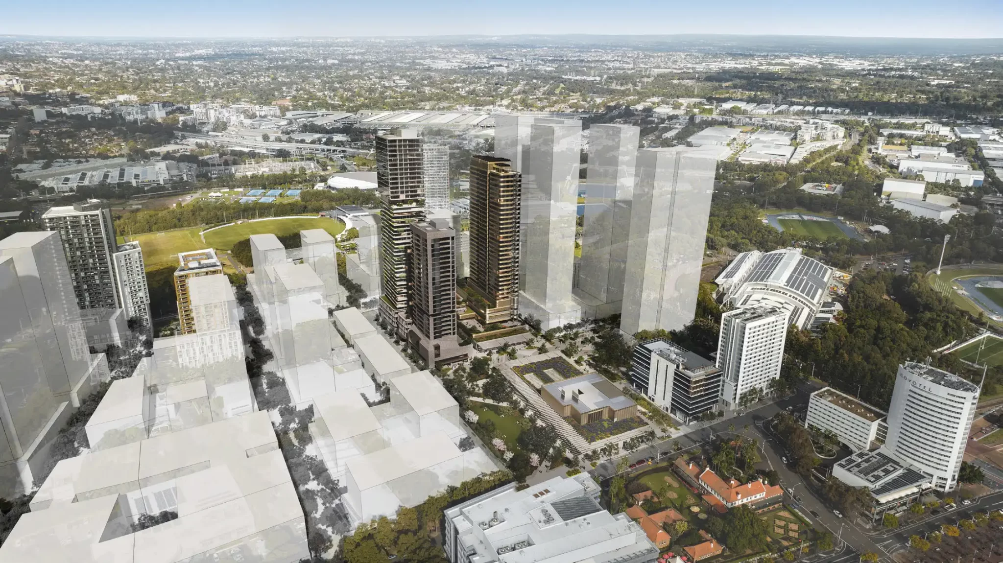 Aerial render of Sydney Olympic Park showing proposed high-rise residential towers above the future metro station, surrounded by existing and planned buildings.